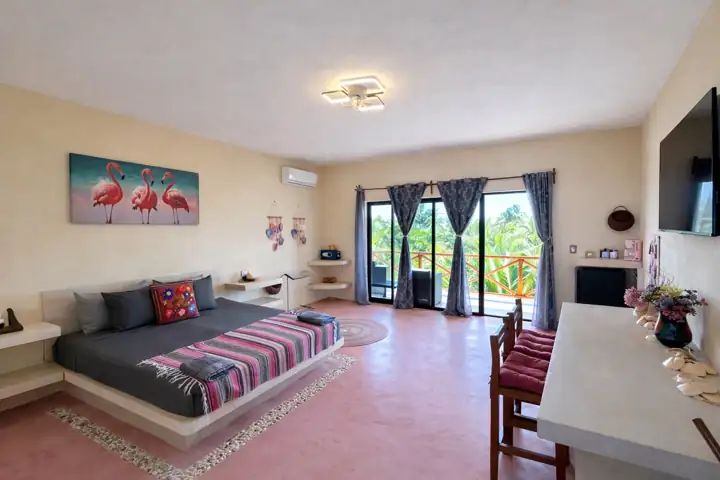 Flamingos Room with flamingo artwork, platform bed and balcony doors