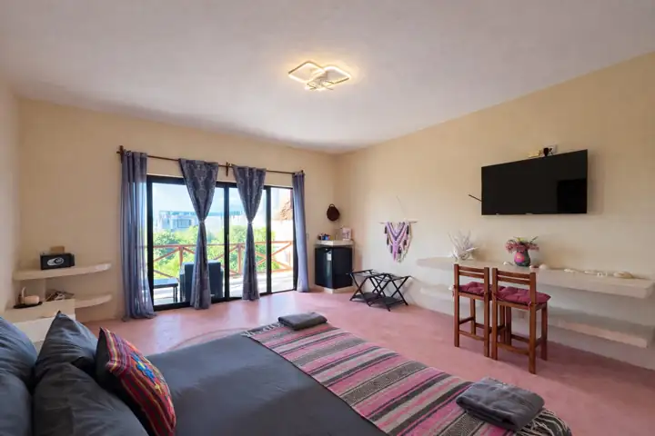 Flamingos Room on the third floor with glass doors to a private ocean-view balcony