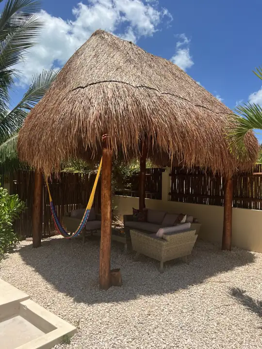 Thatched garden palapa with hammock and outdoor sofa