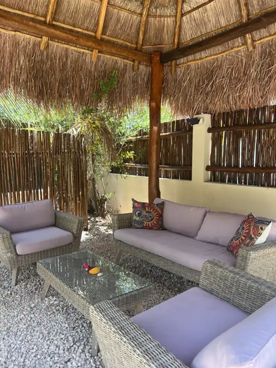 Outdoor lounge with wicker sofas under the palapa