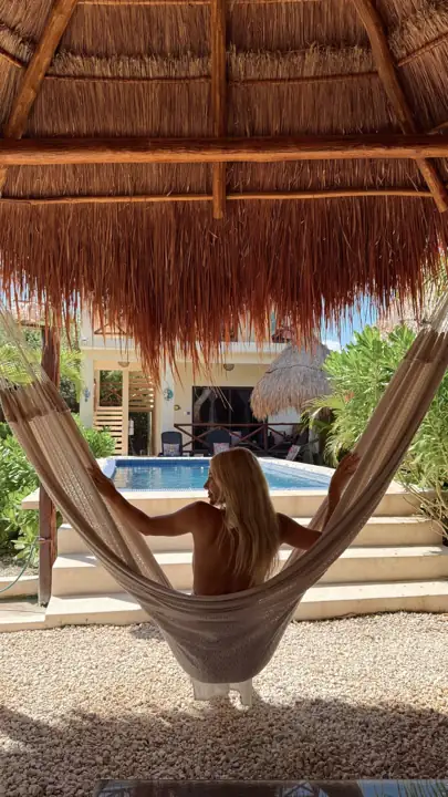 Hammock under the palapa with the pool beyond