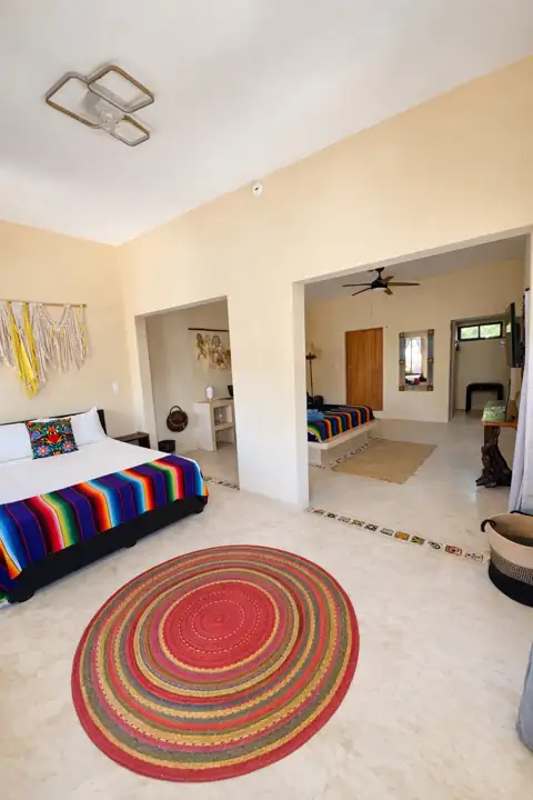 Luma Garden room with platform bed, serape throw and round woven rug