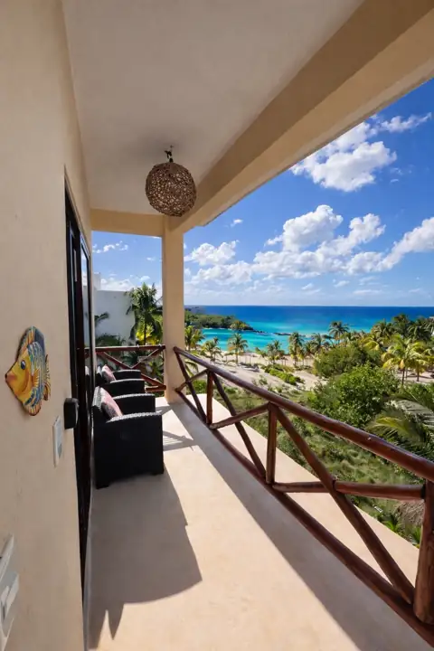 Private balcony overlooking palms and the turquoise Caribbean near Punta Coco, Holbox