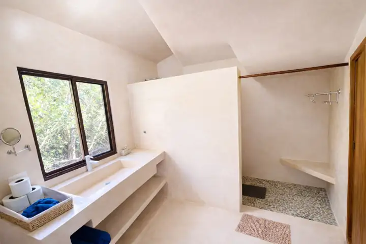 Bright ensuite bathroom with window, vanity and walk-in shower